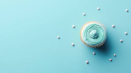 Wall Mural - Blue Background Flat Lay Cupcake with Swirled Frosting and Decorative Sprinkles Perfect for Desserts and Baking Promotions