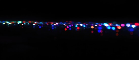 Wall Mural - vibrant display of multicolored lights reflecting in the dark creating a festive and enchanting atmo