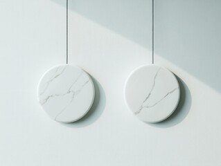 Poster - Contemporary Marble Circles Hanging on a Light Textured Wall in a Minimalist Space with Soft Ambient Light