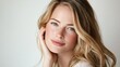 © ASA Creative - A close-up portrait of a beautiful young woman with blonde long hair gently touching her face, and a serene expression, showcasing natural beauty and elegance and tranquility, professional studio port
