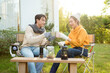 © tonefotografia - Enjoying Warm Drinks and Conversation in a Sunny Outdoor Garden During Autumn Afternoon