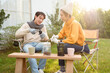 © tonefotografia - Enjoying Warm Drinks and Conversation in a Sunny Outdoor Garden During Autumn Afternoon