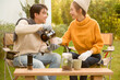 © tonefotografia - Enjoying Warm Drinks and Conversation in a Sunny Outdoor Garden During Autumn Afternoon