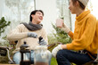 © tonefotografia - Enjoying Warm Drinks and Conversation in a Sunny Outdoor Garden During Autumn Afternoon