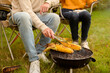 © tonefotografia - Couple Enjoys Grilling Outdoors in a Cozy Garden Setting During a Sunny Afternoon