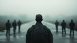 © musa - Lone soldier in camouflage facing a group of soldiers in the fog.