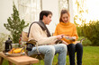 © tonefotografia - Couple Enjoys Grilling Outdoors in a Cozy Garden Setting During a Sunny Afternoon