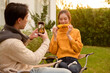 © tonefotografia - Couple Enjoys Grilling Outdoors in a Cozy Garden Setting During a Sunny Afternoon