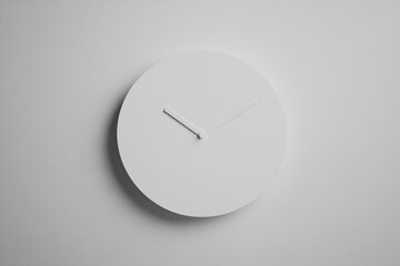 Poster - White minimalistic wall clock displaying time in a modern interior setting during daylight hours. Generative AI