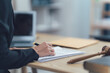 © Kritdanai - Legal Professional Signing Documents: A close-up of a legal professional signing a document,  with a gavel and other legal documents  in the foreground.