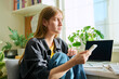 © Valerii Honcharuk - Serious teenage female sitting at home reading texting on smartphone