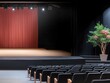 © Katavudh - A modern theater stage with red curtains and elegant seating.