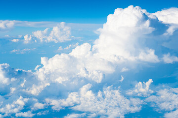Wall Mural - blue sky with a clouds. Clear blue sky panoramic background with small white clouds. Partly cloudy. White fluffy clouds in the blue sky.