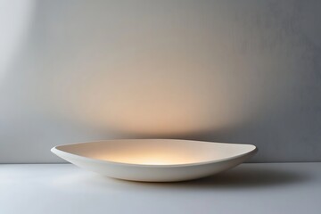 Wall Mural - A white ceramic bowl illuminated from within, casting a warm glow.