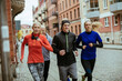 © Geber86 - Young people jogging on a city street together