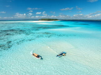 Wall Mural - aerial view of colorful boats and yachts in transparent water on sunny summer day. mnemba island, za