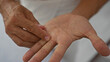© Krakenimages.com - Hispanic man indoors at a wellness salon examining his palm, highlighting hand acupressure techniques in a calm spa setting.
