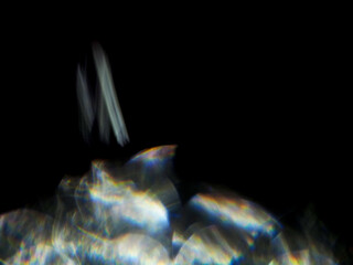 Wall Mural - a blurry image of a light flare with a dark background. the image has a moody and mysterious feel to