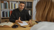 © Krakenimages.com - Judge talking to female client in lawyer office with law books and scale on the desk indoors