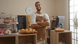 © Krakenimages.com - Handsome man with beard standing with arms crossed in bakery shop interior with pastries on display