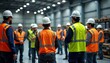 © miss irine - Industrial workers gather in large warehouse for safety training. Workers wear safety vests, hard hats. Instructor guides training. Group listens attentively. Pro training session on safety