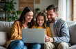 © miss irine - Happy family sits cozy on sofa watching laptop. Mom dad and child bond over video. Modern living room interior. Casual attire. Joyful family time. Tech use in home.
