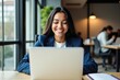 © velikiyzayats - Smiling Woman Working on Laptop in Modern Office Setting, Engaged in Professional Tasks Amid Colleagues, Emphasizing Productivity and Positive Atmosphere