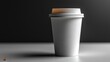 © darion - A simple white coffee cup against a dark background.