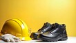 © hendar - Safety equipment includes a yellow hard hat, a pair of black safety shoes, clear safety glasses, and white gloves, arranged with a plain background and blank space for blank writing.labour day