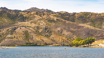 Wall Mural - Summer water activities in cromwell new zealand lake mountains hills beautiful nature landscape hot day 