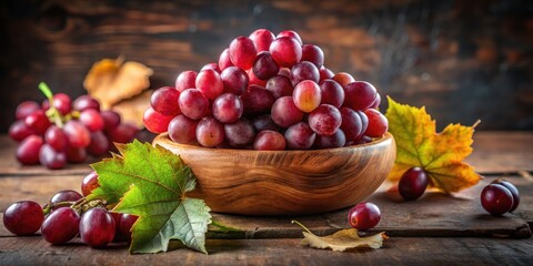 Wall Mural - Fresh red grapes arranged artfully in a wooden bowl with some scattered leaves, on a rustic kitchen table , rustic