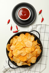 Wall Mural - Potato chips in a bowl with chili pepper and sauce