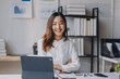 © ARMMY PICCA - Young businesswoman with her arms crossed in her office, looking happy and confident. She is working late in the office