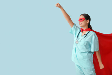 Poster - Beautiful female doctor dressed as super hero on blue background