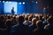 © piyawat - 'Business presentation in a illuminated auditorium with focused audience listening to speaker on stage in blue lighting.'