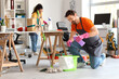 © Pixel-Shot - Male janitor pouring detergent into bucket in office after New Year party