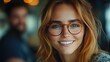 © afif - Smiling woman in glasses, cafe setting, blurred background