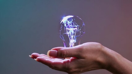 Aufkleber - A hand holding a holographic lightbulb surrounded by swirling energy, symbolizing a breakthrough idea in the process of creation.
