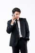 © Dimas - A man in a suit is holding a cell phone and smiling
