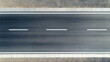 © Keopaserth - seamless top down view of modern asphalt highway with clear lane markings, showcasing smooth surface and surrounding gravel. image evokes sense of openness and tranquility