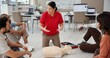 © peopleimages.com - First aid, training and people in office for safety compliance, company healthcare or medical demonstration. Paramedic course, cpr and teaching emergency rescue technique with mannequin in business