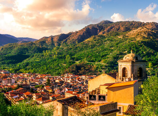 Wall Mural - Mountain town view. Mountain landscape of  beautiful village in Sicily, Italy. A town in a beautiful mountain valley. Mountain valley town during sunset in evening light