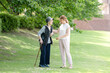 © Masakazu Tokashiki - At grass area of A park with good atmosphere with canal in Toyama Prefecture. Old woman in her 90s and Japanese woman in her thirties are walking around the park.