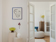 © FollowTheFlow - Modernist chair with woven seat and backrest against a minimal interior. Abstract art on the wall complements the mid-century vibe. A blurred figure adds movement to the scene.