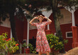 © YURII Seleznov - Young woman in ethnic dress and hat exploring the vibrant streets of Malacca, Malaysia. A blend of cultural heritage, colorful architecture, and tropical charm. Perfect travel and lifestyle moments.