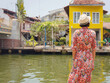 © YURII Seleznov - Young woman in ethnic dress and hat exploring the vibrant streets of Malacca, Malaysia. A blend of cultural heritage, colorful architecture, and tropical charm. Perfect travel and lifestyle moments.
