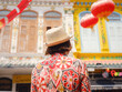 © YURII Seleznov - Young woman in ethnic dress and hat exploring the vibrant streets of Malacca, Malaysia. A blend of cultural heritage, colorful architecture, and tropical charm. Perfect travel and lifestyle moments.