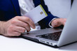 © ismael - Man holding credit card and using laptop computer. Online shopping concept.