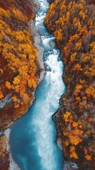 Wall Mural - Vibrant autumn landscape featuring a rushing river surrounded by colorful foliage in a mountainous terrain