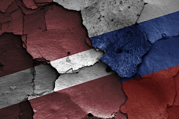 Wall Mural - Flags of Latvia and Russia painted on cracked wall